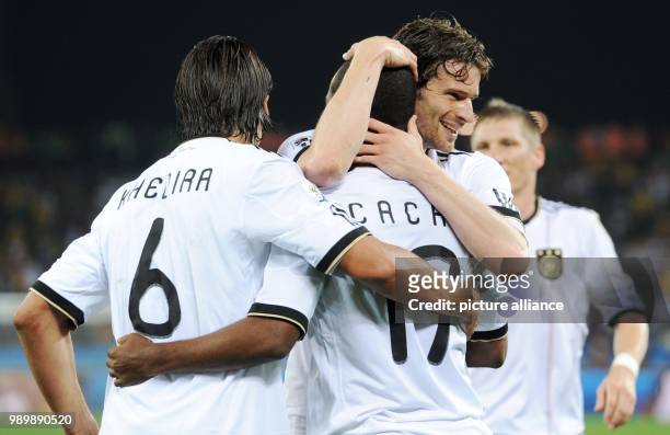 Cacau of Germany is congratulated by Sami Khedira and Arne Friedrich after scoring the 4-0 lead during the FIFA World Cup 2010 group D match between...