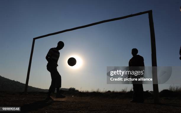 Local boys play soccer on a field at the Atteridgeville township near Pretoria, South Africa, 16 June 2010. South Africa hosts the 2010 FIFA World...