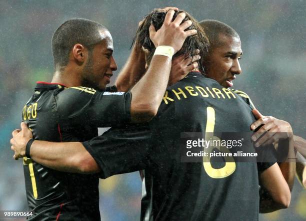 Sami Khedira of Germany celebrates with Dennis Aogo and Jerome Boateng after scoring the 3-2 during the 2010 FIFA World Cup third place match between...
