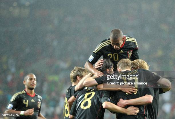 Sami Khedira of Germany celebrates with his teammates after scoring the 3-2 during the 2010 FIFA World Cup third place match between Uruguay and...