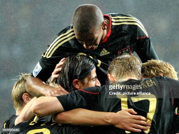 Sami Khedira of Germany celebrates with his teammates after scoring the 3-2 during the 2010 FIFA World Cup third place match between Uruguay and...