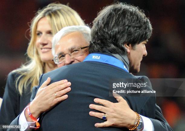 German coach Joachim Loew embraces DFB President Theo Zwanziger after the 2010 FIFA World Cup third place match between Uruguay and Germany at the...