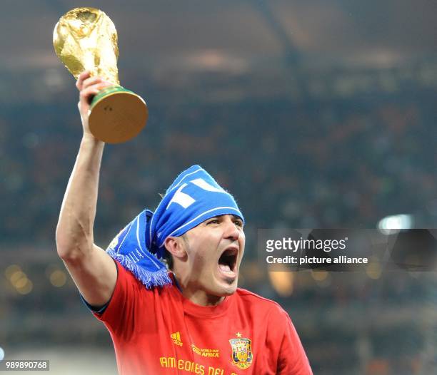 Spain's David Villa lifts the World Cup trophy after the 2010 FIFA World Cup final match between the Netherlands and Spain at Soccer City Stadium in...