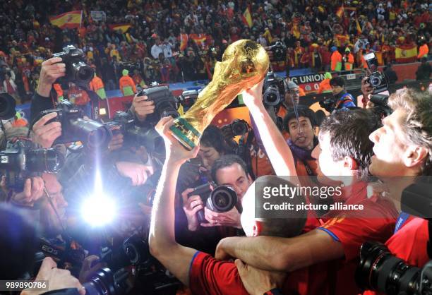 Andres Iniesta celebrates with the trophy after the 2010 FIFA World Cup final match between the Netherlands and Spain at the Soccer City Stadium in...