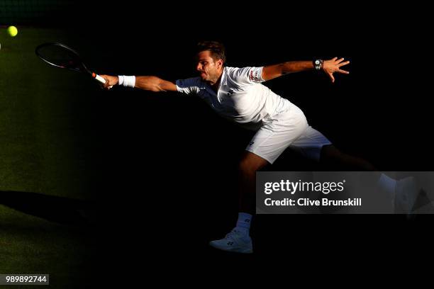 Stanislas Wawrinka of Switzerland returns against Grigor Dimitrov of Bulgaria during their Men's Singles first round match on day one of the...