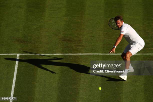 Stanislas Wawrinka of Switzerland returns against Grigor Dimitrov of Bulgaria during their Men's Singles first round match on day one of the...