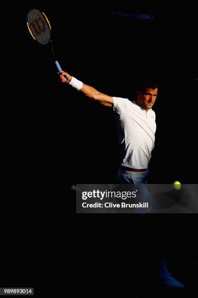 Grigor Dimitrov of Bulgaria returns against Stanislas Wawrinka of Switzerland during their Men's Singles first round match on day one of the...