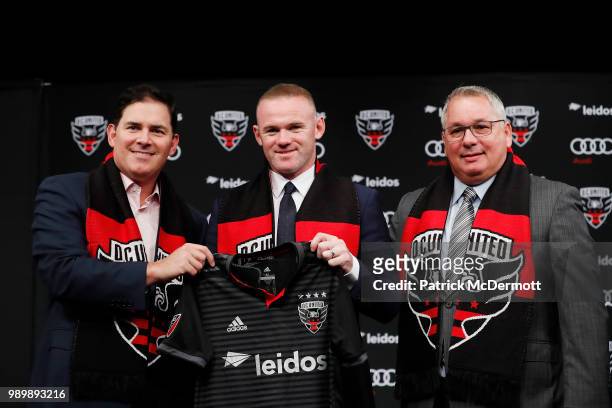 United Managing Partner and CEO Jason Levien, Wayne Rooney of DC United, and DC United General Manager Dave Kasper pose with a jersey during his...