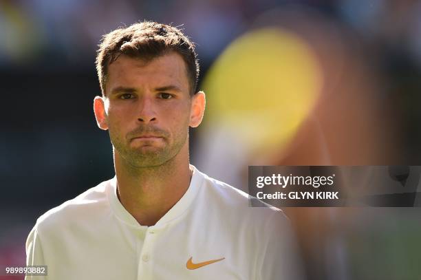 Bulgaria's Grigor Dimitrov prepares to serve to Switzerland's Stan Wawrinka during their men's singles first round match on the first day of the 2018...