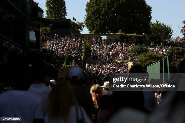 Crowds of people make their way through Wimbledon at All England Lawn Tennis and Croquet Club on July 2, 2018 in London, England.