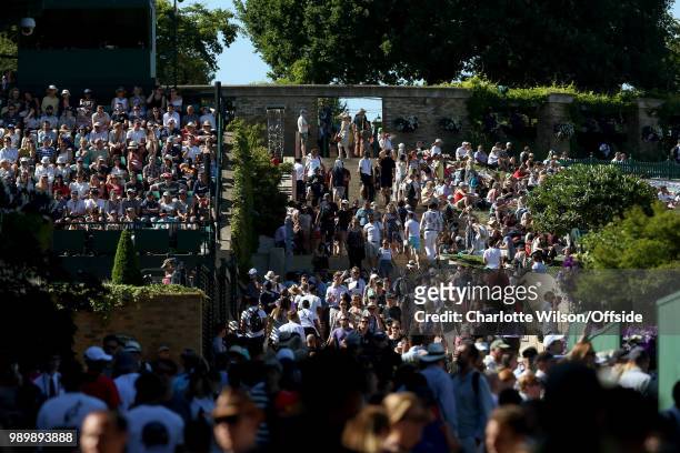 Crowds of people make their way through Wimbledon at All England Lawn Tennis and Croquet Club on July 2, 2018 in London, England.