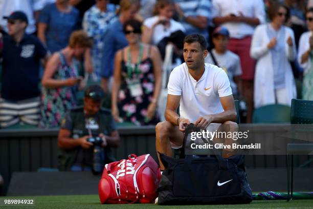 Grigor Dimitrov of Bulgaria appears dejected after being defeated by Stanislas Wawrinka of Switzerland during their Men's Singles first round match...