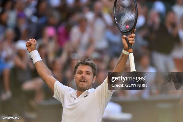 Switzerland's Stan Wawrinka celebrates after beating Bulgaria's Grigor Dimitrov 6-1, 7-6, 7-6, 6-4 in their men's singles first round match on the...