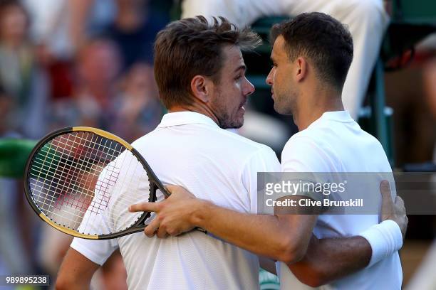 Stanislas Wawrinka of Switzerland shakes hands with Grigor Dimitrov of Bulgaria after their Men's Singles first round match on day one of the...