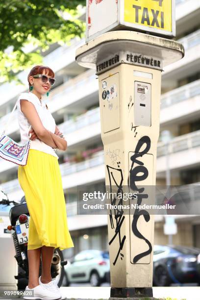 Sussan Zeck, wearing Madeleine and Lacoste shoes, poses during a street style photo session on July 2, 2018 in Berlin, Germany.