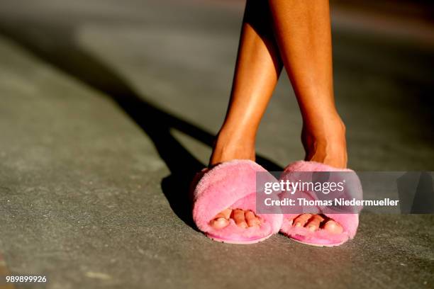 Sussan Zeck, wearing shoes Emu Australia, poses during a street style photo session on July 2, 2018 in Berlin, Germany.