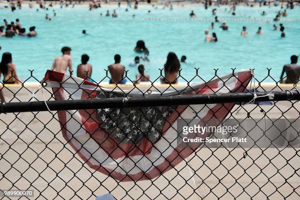 People enjoy a hot afternoon at the Astoria Pool in the borough of Queens on July 2, 2018 in New York City. New York City and much of the East Coast...