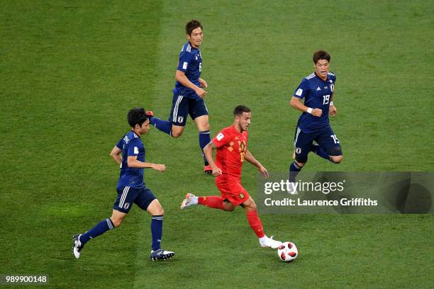 Eden Hazard of Belgium is closed down by Gaku Shibasaki, Hiroki Sakai and Genki Haraguchi of Japan during the 2018 FIFA World Cup Russia Round of 16...