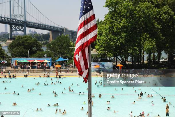 People enjoy a hot afternoon at the Astoria Pool in the borough of Queens on July 2, 2018 in New York City. New York City and much of the East Coast...