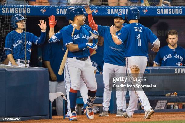 Toronto Blue Jays Infielder Yangervis Solarte and teammate Starting pitcher Marcus Stroman congratulate Infielder Aledmys Diaz after he scored as...