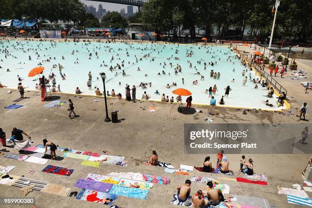 People enjoy a hot afternoon at the Astoria Pool in the borough of Queens on July 2, 2018 in New York City. New York City and much of the East Coast...