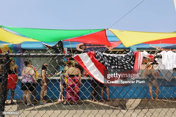 People wait in line at the snack bar on a hot afternoon at the Astoria Pool in the borough of Queens on July 2, 2018 in New York City. New York City...