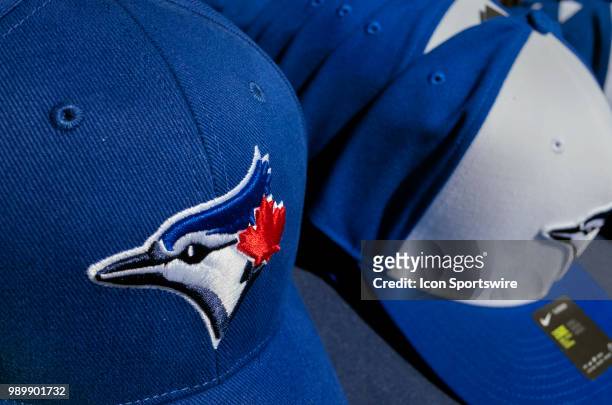 Toronto Blue Jays hats are stacked up for sale by vendors outside the Rogers Centre before the MLB game between the Detroit Tigers and the Toronto...