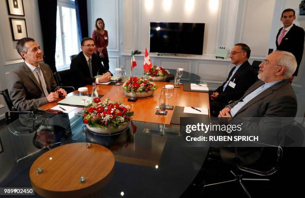 Iranian Foreign Minister Mohammad Javad Zarif speaks with Swiss Foreign Minister Ignazio Cassis at the start of a meeting in Bern on July 2, 2018.