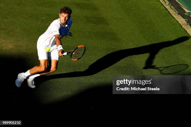Pablo Carreno Busta of Spain returns against Radu Albot of Moldova on day one of the Wimbledon Lawn Tennis Championships at All England Lawn Tennis...