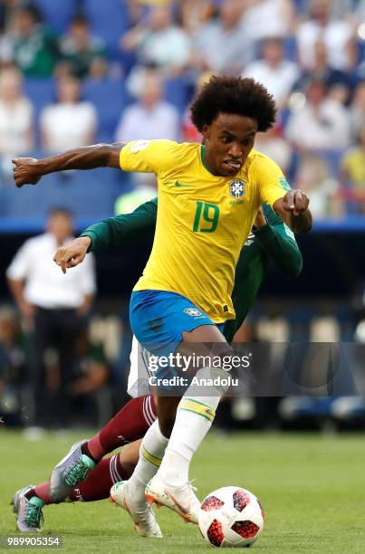 Willian of Brazil in action against player of Mexico during the 2018 FIFA World Cup Russia Round of 16 match between Brazil and Mexico at the Samara...