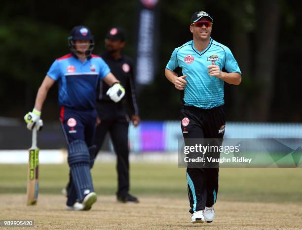 David Warner of Winnipeg Hawks runs down the wicket as Steve Smith of Toronto Nationals looks on during a change of ends in a Global T20 Canada match...