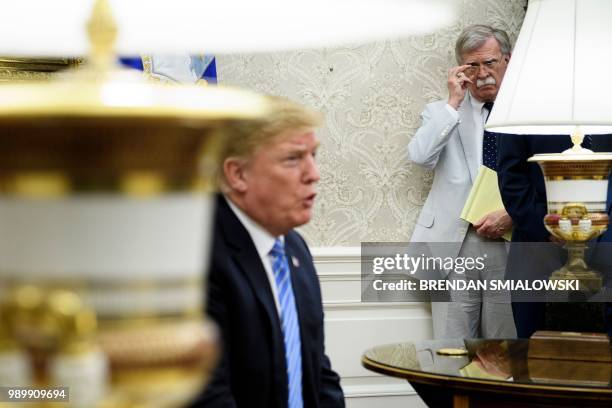 National Security Advisor John Bolton listens while US President Donald Trump speaks to the press before a meeting with Dutch Prime Minister Mark...