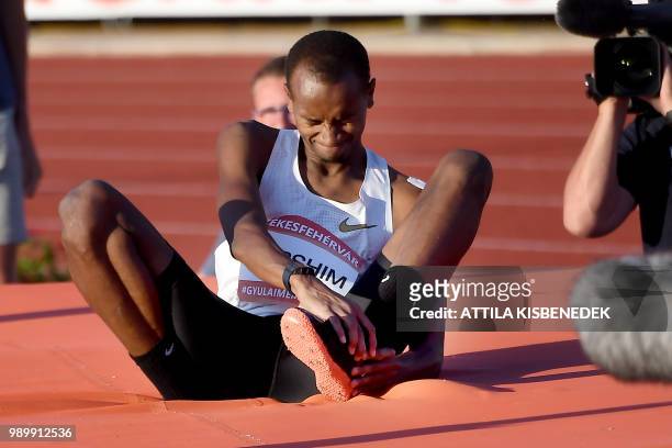 Qatar's winner Mutaz Essa Barshim touches his injured ankle after his world record attempt on 2.36 meters during the Gyulai Istvan Memorial -...