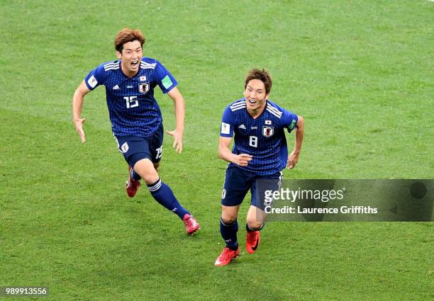 Genki Haraguchi of Japan celebrates with team mate Yuya Osako after scoring his team's first goal during the 2018 FIFA World Cup Russia Round of 16...