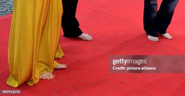 July 2018, Germany, Munich: Actress Meret Becker , musician Blixa Bargeld, and actress Amanda Plummer, arriving barefoot to the CineMerit Gala....