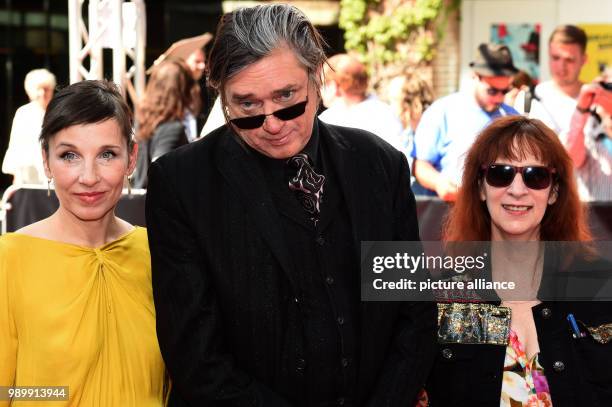 July 2018, Germany, Munich: Actress Meret Becker , musician Blixa Bargeld, and actress Amanda Plummer, arriving to the CineMerit Gala. Photo: Felix...