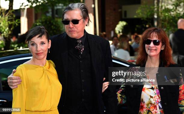 July 2018, Germany, Munich: Actress Meret Becker , musician Blixa Bargeld, and actress Amanda Plummer, arriving to the CineMerit Gala. Photo: Felix...