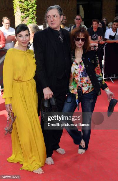 July 2018, Germany, Munich: Actress Meret Becker , musician Blixa Bargeld, and actress Amanda Plummer, arriving to the CineMerit Gala. Photo: Felix...