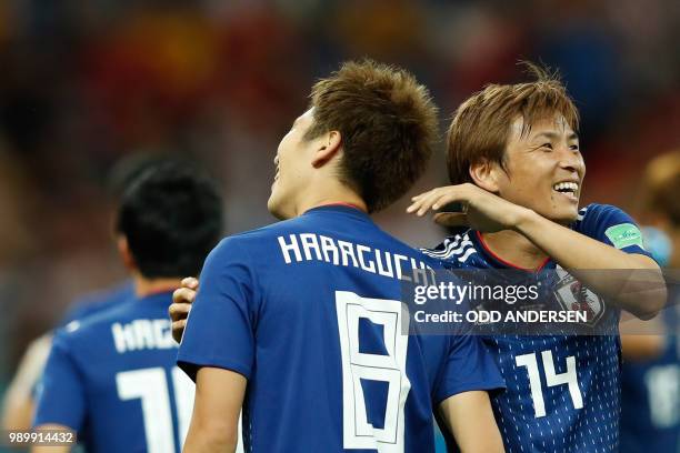 Japan's forward Genki Haraguchi celebrates with teammate Japan's midfielder Takashi Inui after scoring during the Russia 2018 World Cup round of 16...