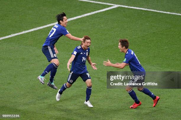 Takashi Inui of Japan celebrates with team mates Makoto Hasebe and Gaku Shibasaki after scoring his team's second goal during the 2018 FIFA World Cup...