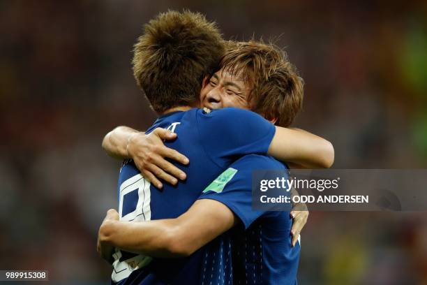 Japan's midfielder Takashi Inui celebrates with teammate Japan's forward Genki Haraguchi after scoring during the Russia 2018 World Cup round of 16...