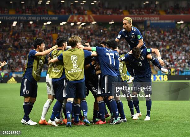 Takashi Inui of Japan celebrates with team mates after scoring his team's second goal during the 2018 FIFA World Cup Russia Round of 16 match between...