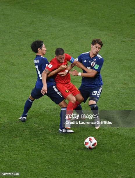 Eden Hazard of Belgium is challenged by Gaku Shibasaki of Japan and Hiroki Sakai of Japan during the 2018 FIFA World Cup Russia Round of 16 match...