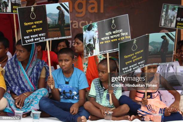 Activists with the family members of Trilochan Mahato and Dulal Kumar who were killed after the West Bengal panchayat election protest against their...