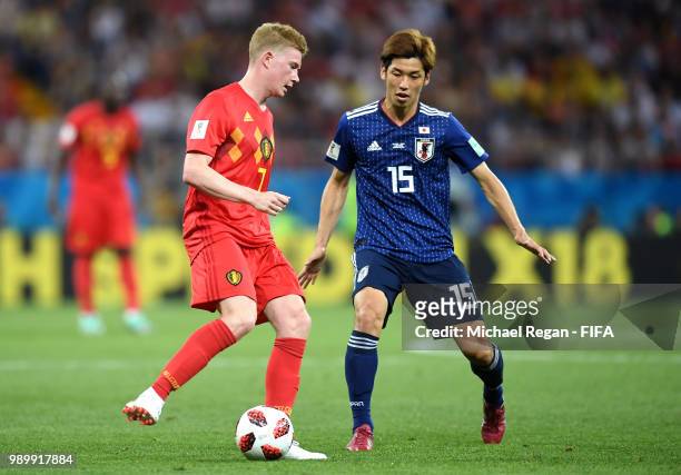 Kevin De Bruyne of Belgium is chellenged by Yuya Osako of Japan during the 2018 FIFA World Cup Russia Round of 16 match between Belgium and Japan at...