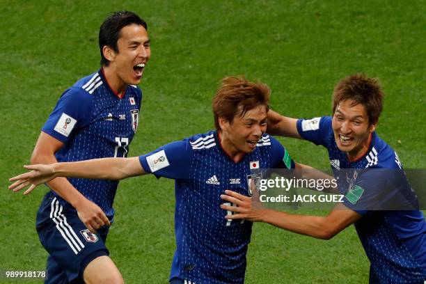 Japan's midfielder Takashi Inui celebrates with Japan's midfielder Makoto Hasebe and Japan's forward Genki Haraguchi after scoring his team's second...