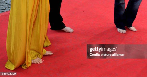 July 2018, Germany, Munich: Actress Meret Becker , musician Blixa Bargeld, and actress Amanda Plummer, arriving barefoot to the CineMerit Gala....