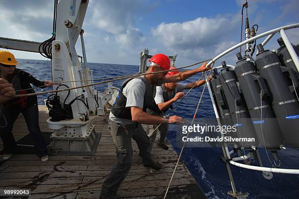 Israeli researchers haul their scientific instruments back onto EcoOcean's marine research vessel Mediterranean Explorer after gathering water...