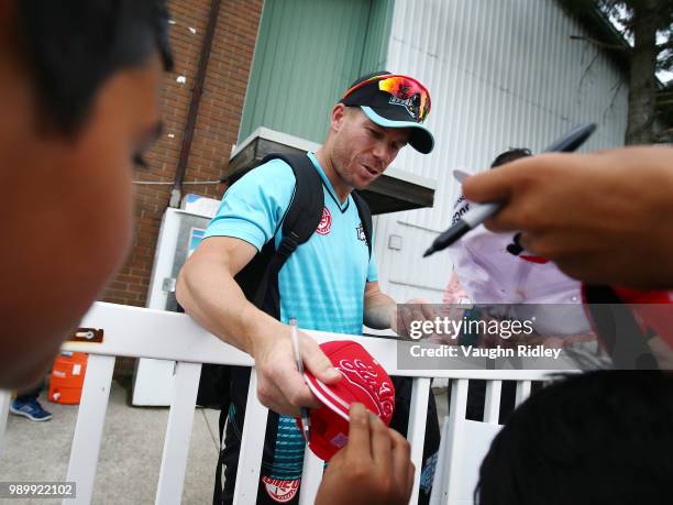 David Warner of Winnipeg Hawks signs autographs following a Global T20 Canada match against Toronto Nationals at Maple Leaf Cricket Club on July 2,...