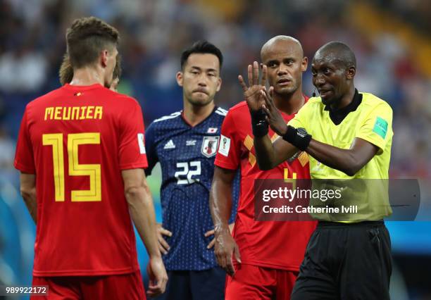 Referee Malang Diedhiou discusses with Thomas Meunier of Belgium during the 2018 FIFA World Cup Russia Round of 16 match between Belgium and Japan at...